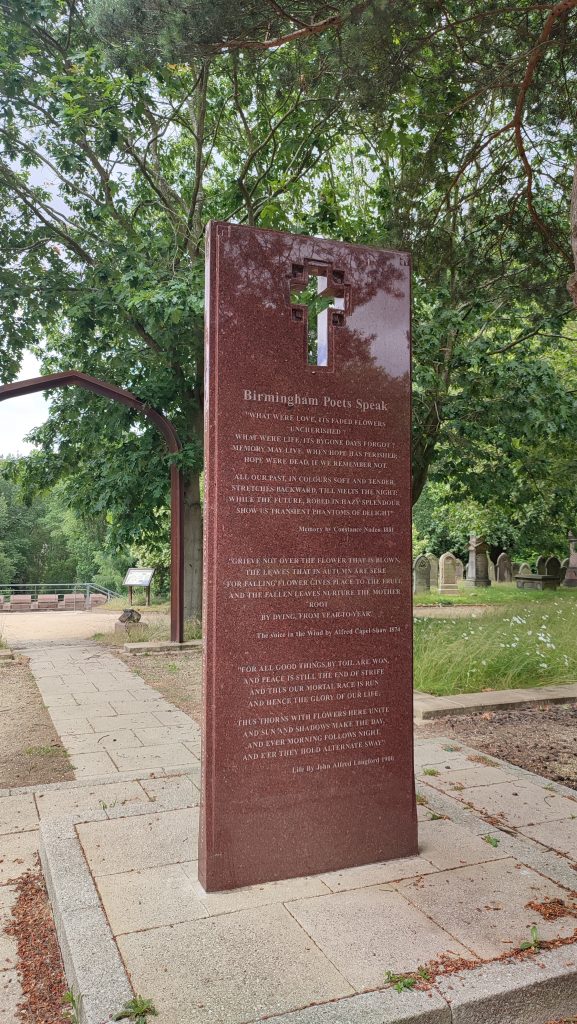 A marble headstone with a poem and a cross
